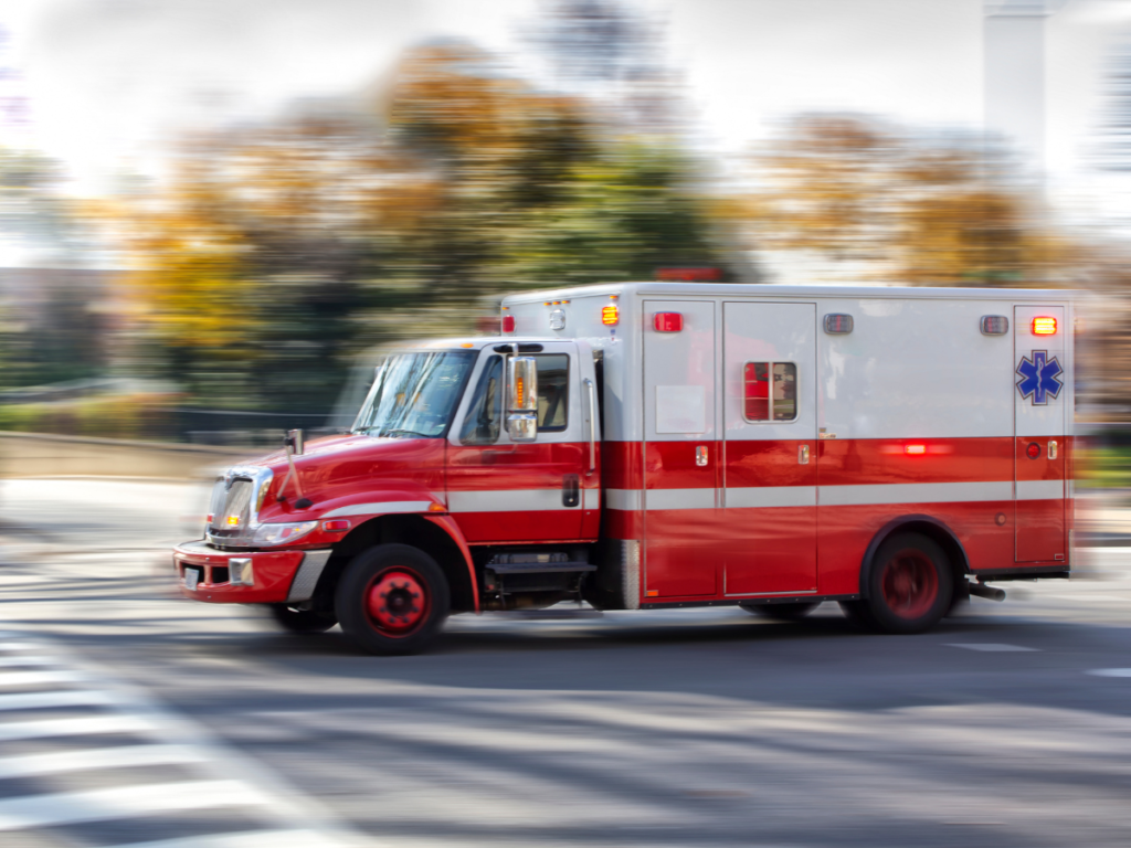 An Ambulance racing through an intersection.